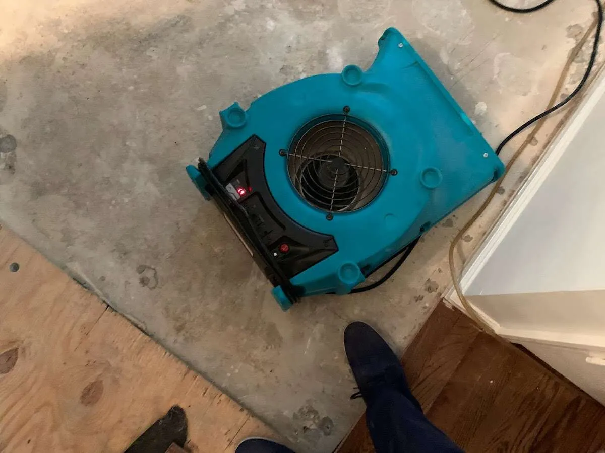 Air mover drying subfloor during Leak Detection & Repair in Rigby
